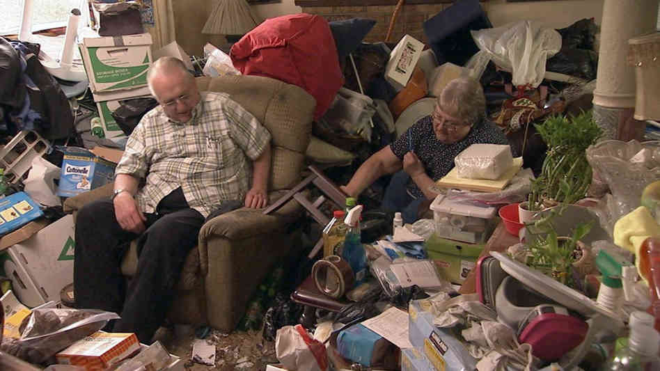 Photo of old couple sitting in a mess