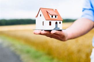 Photo of a man holding house