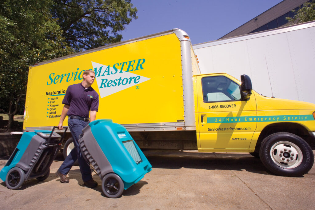 ServiceMaster technician using dehumidifiers for residential water damage restoration in Chicago